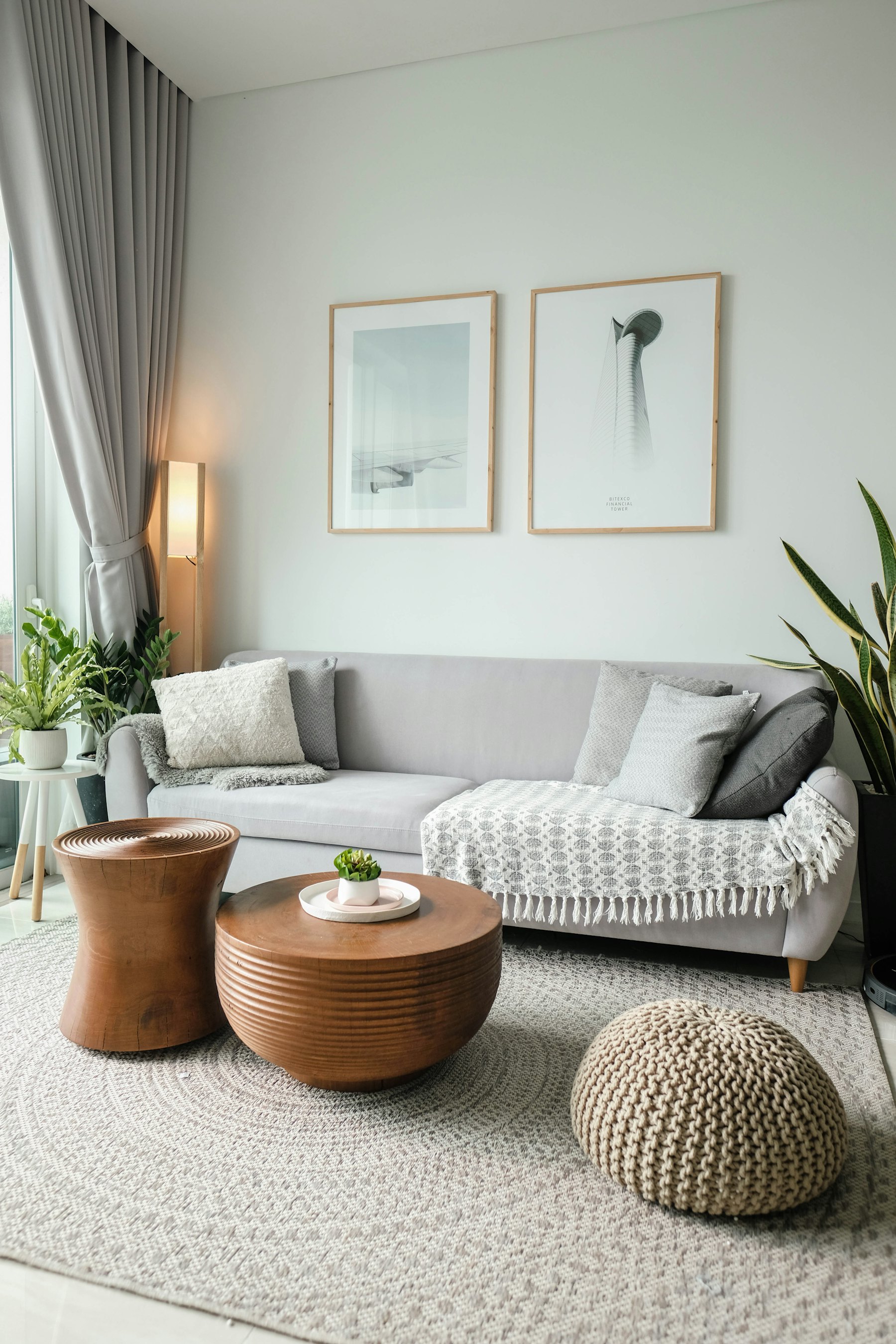 A furnished living room with a grey sofa